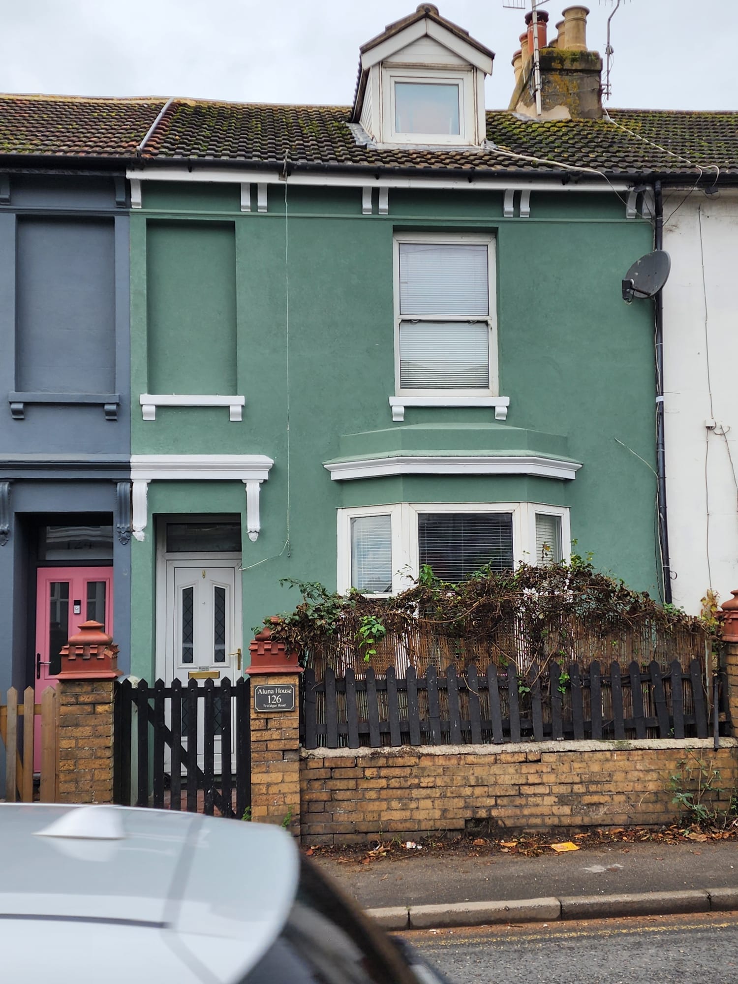 External render finish on a green terraced house in Portslade by Portslade Plastering.