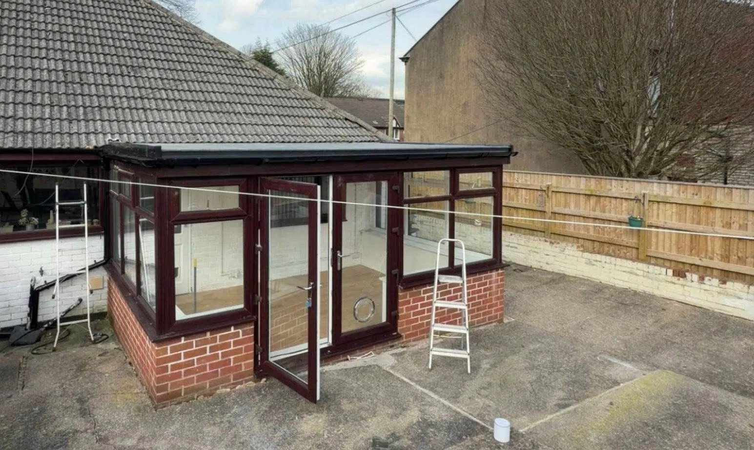 Solid conservatory roof conversion on a brick-based sunroom in Blackburn, Lancashire.