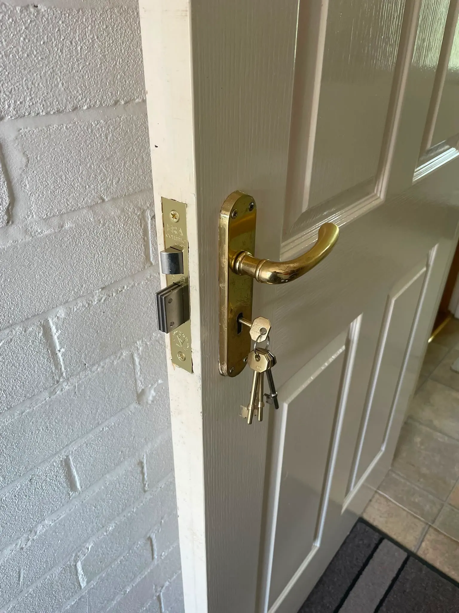 Newly fitted brass ERA mortice lock and handle installed on a white residential door by Locksafe York Ltd