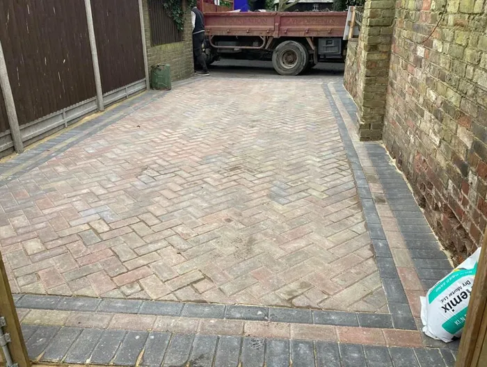 Newly laid block paving driveway in a herringbone pattern with dark grey border, showing a completed professional installation at a home in Kent.