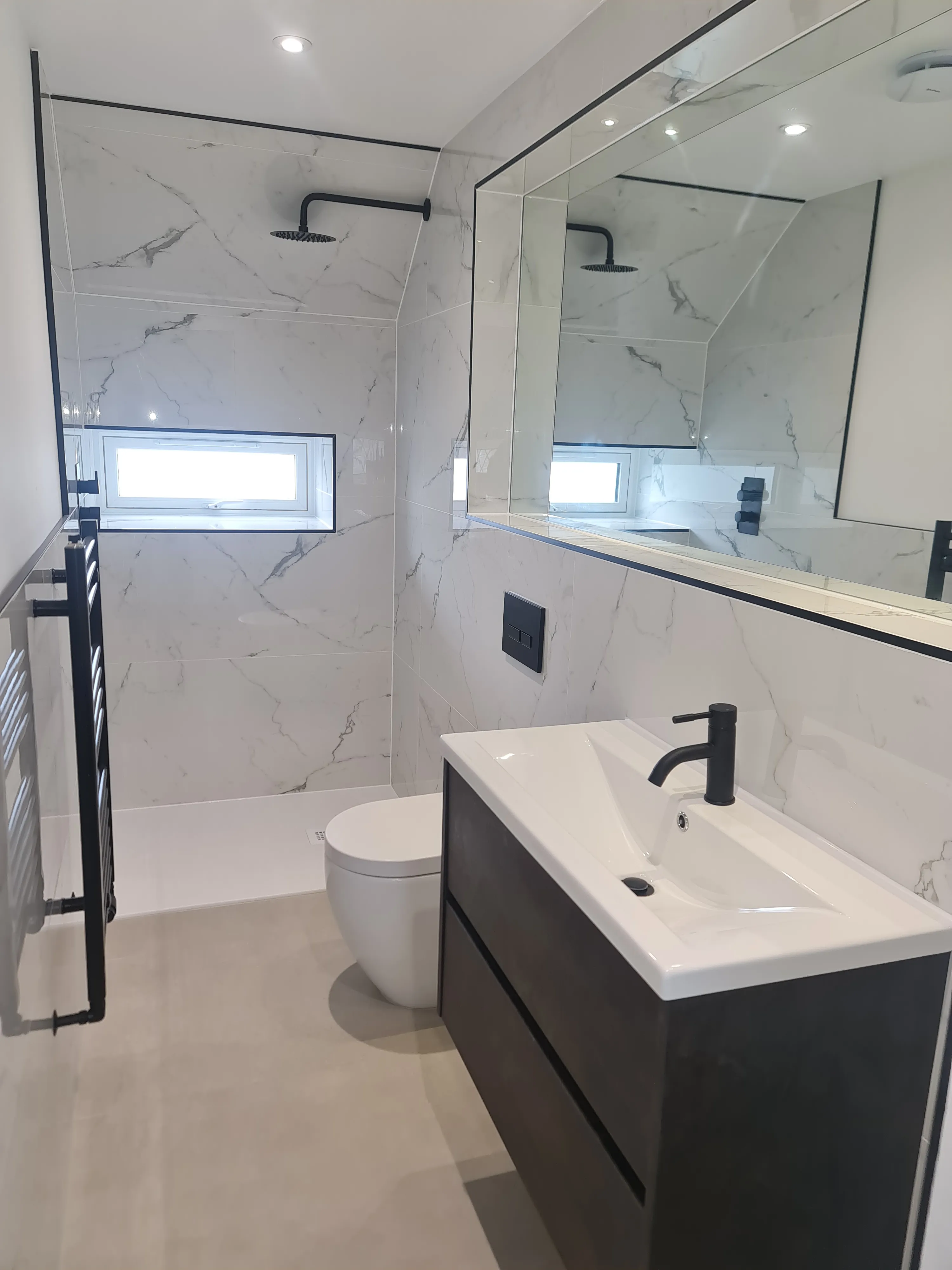 Luxury turnkey bathroom installation in Plymouth featuring bespoke marble tiling and matte black fixtures by Sands & Vossen.