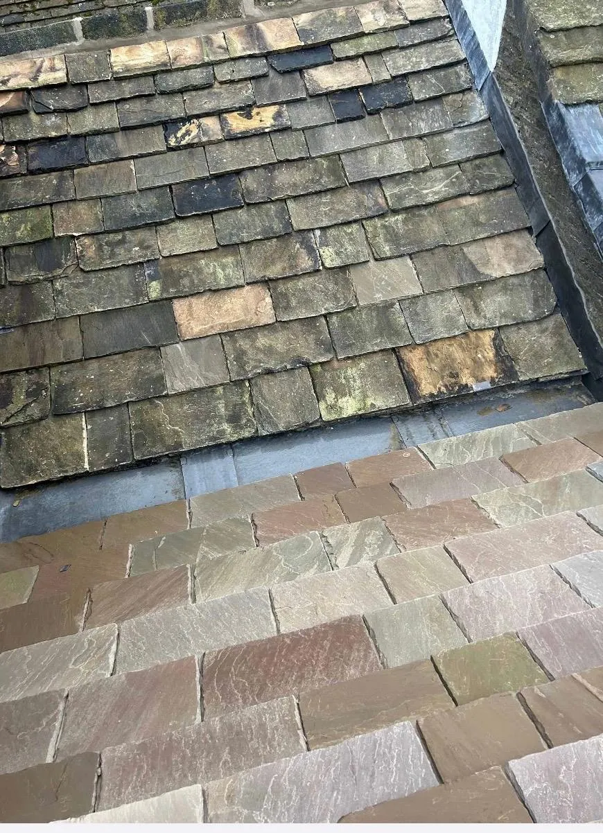 New stone slates being expertly installed on a traditional heritage roof in Holmfirth.