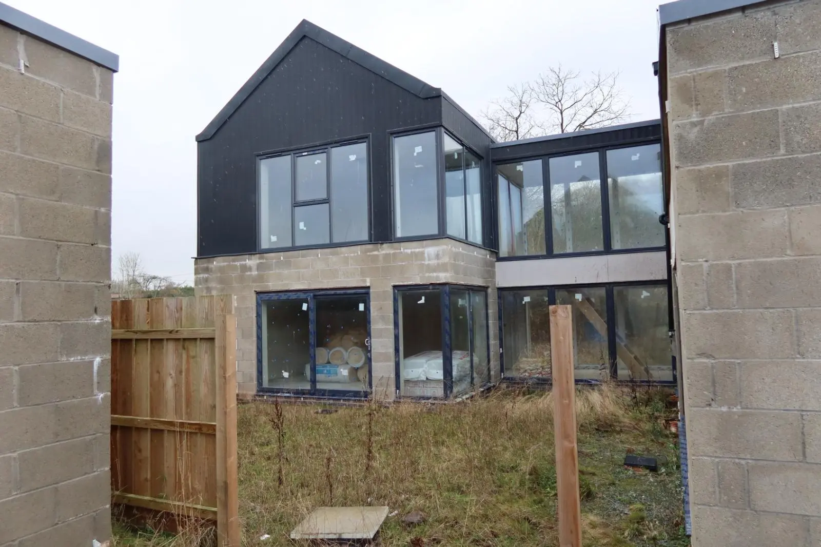 Modern house with exposed blockwork prepared for external wall insulation and rendering in South Wales