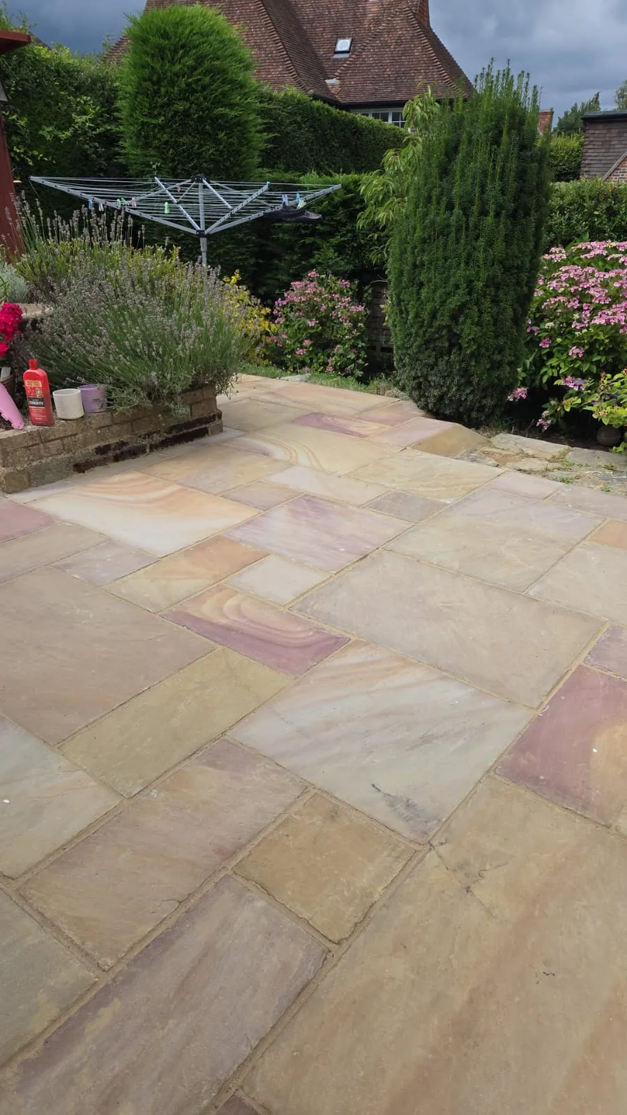 Indian sandstone patio installation in a garden