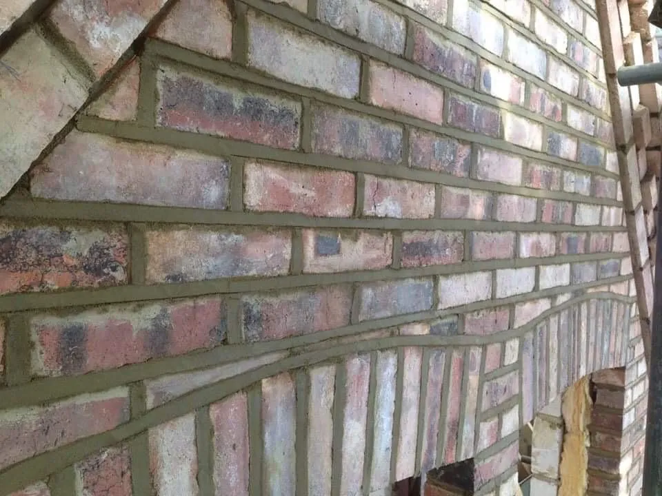 Freshly pointed brickwork on a property wall with an arch detail