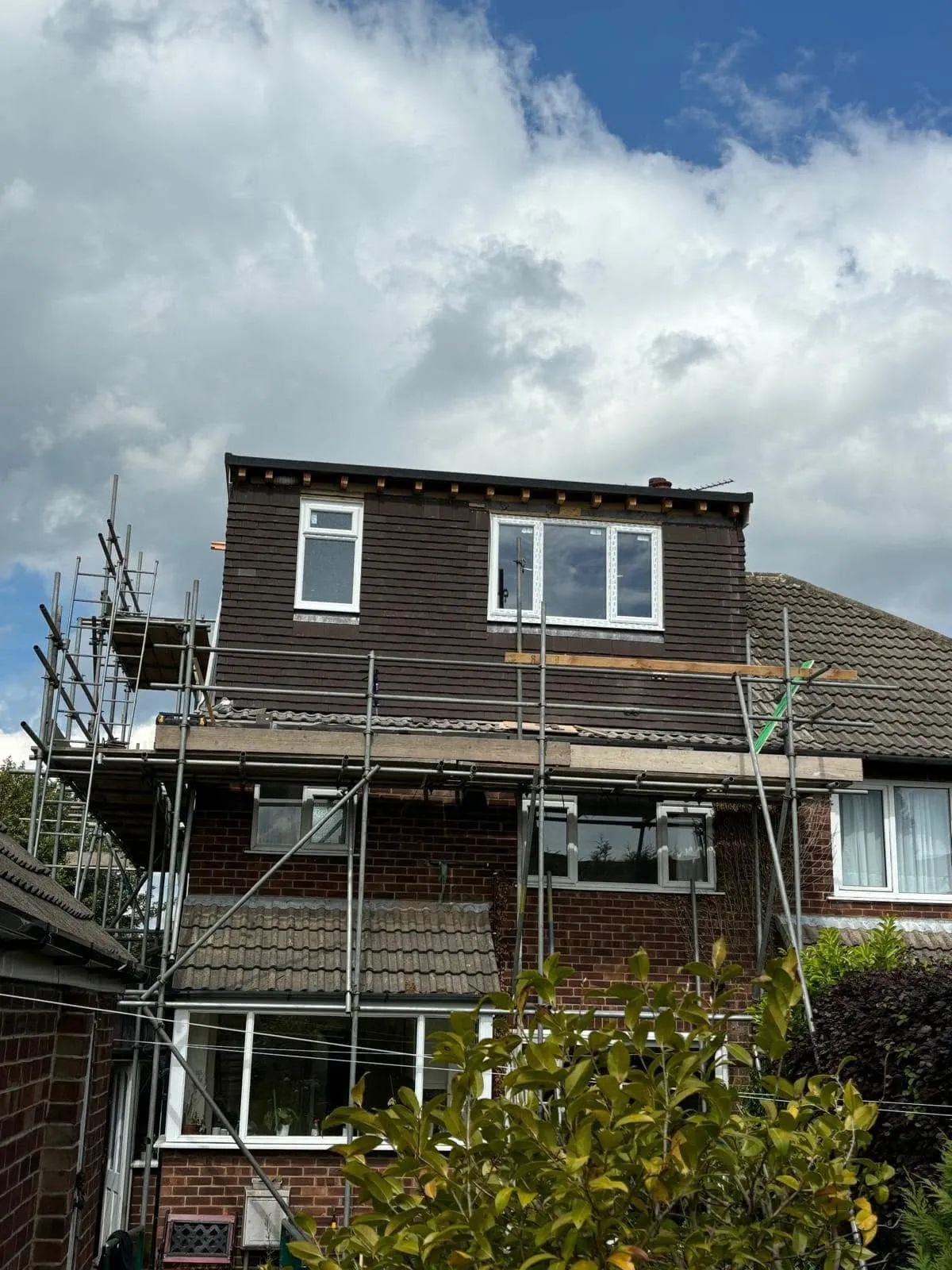 Professional re-roofing and dormer extension project in Leeds with scaffolding