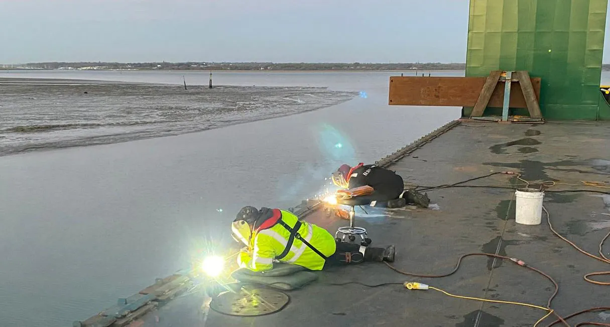 Specialist coded welders carrying out marine fabrication and repairs on a ship deck in Southampton.
