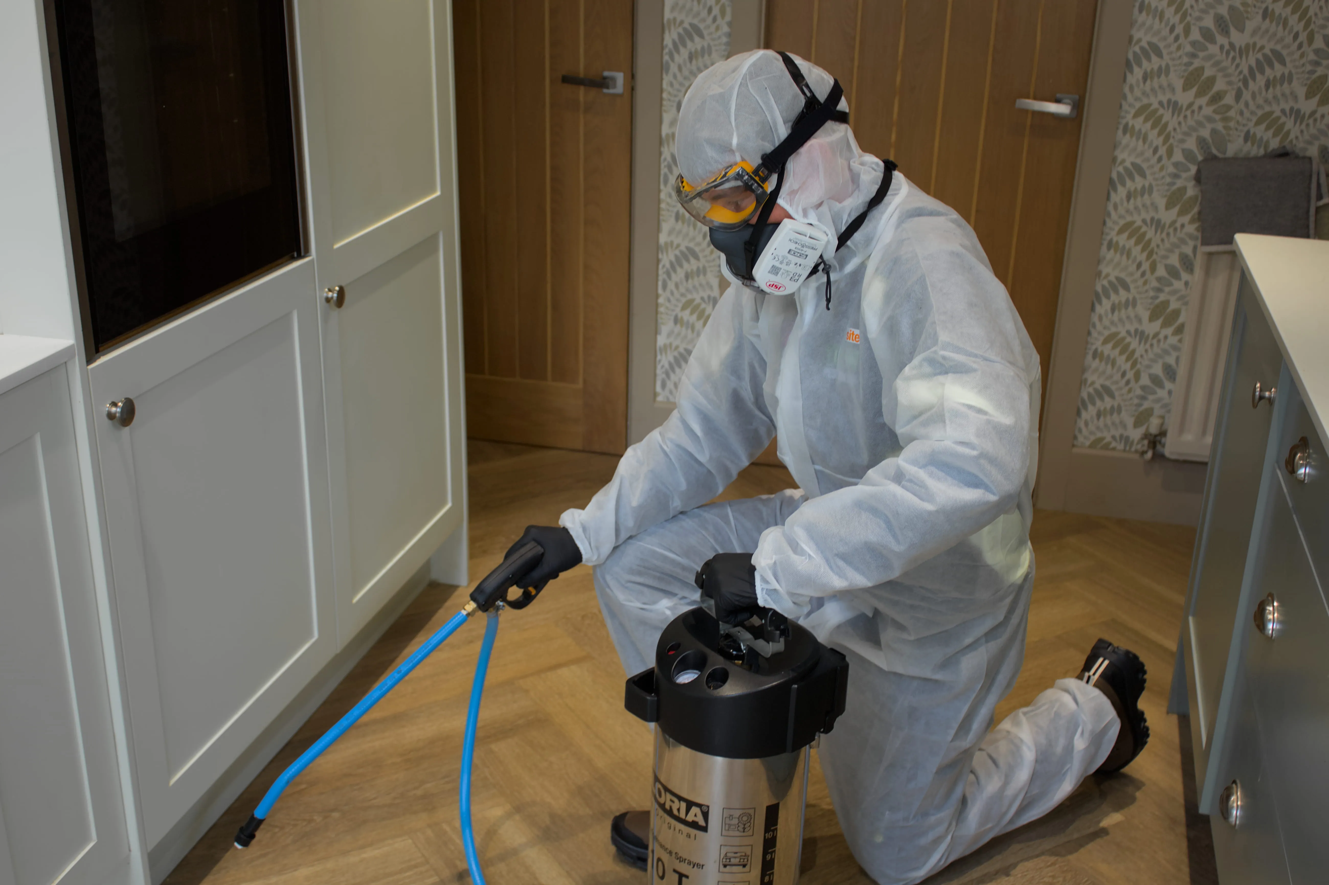 Professional pest control technician from Pest Control Harrogate treating a kitchen for pests