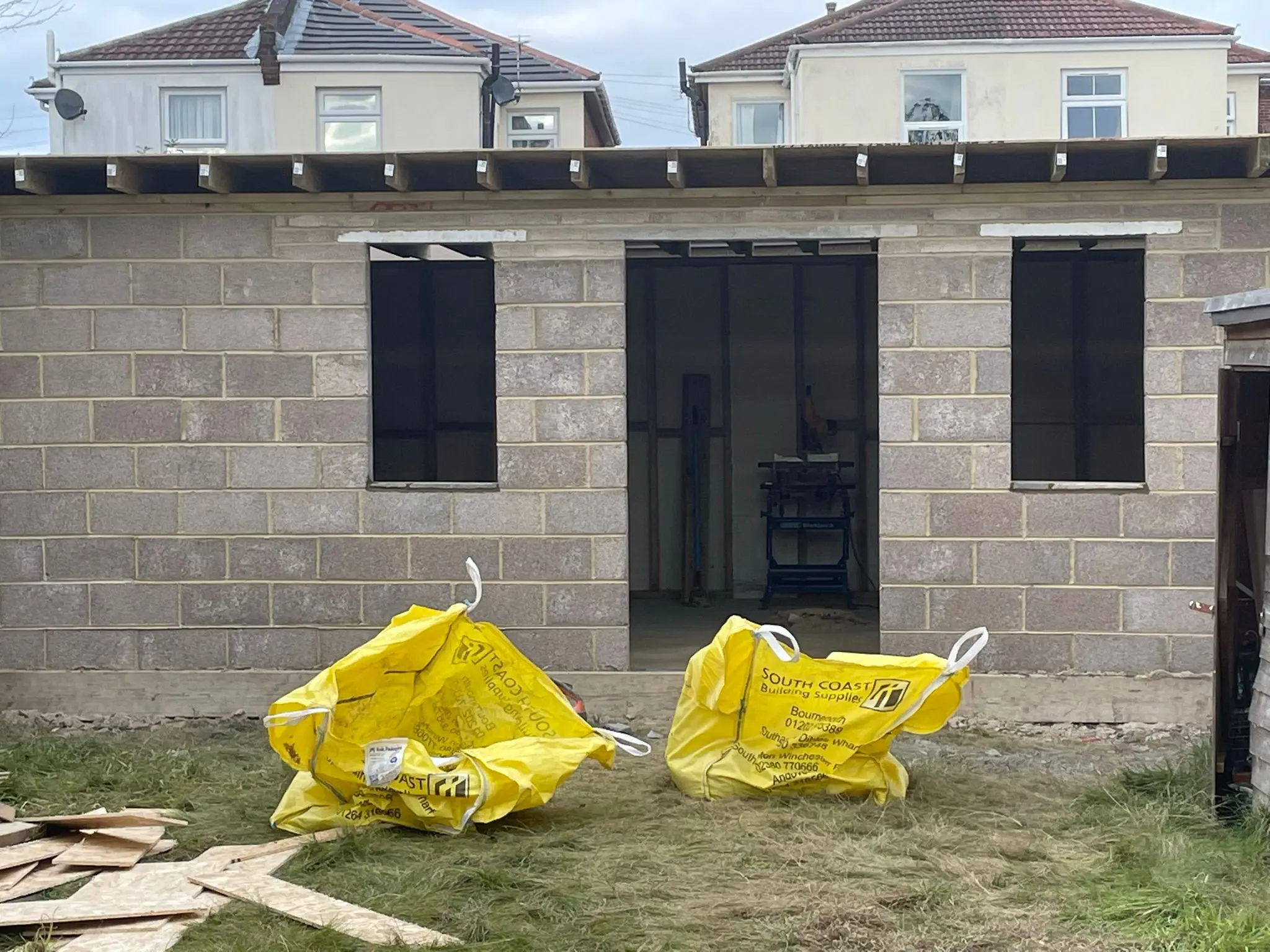 Aline Construction building a single-storey house extension with blockwork and timber roofing