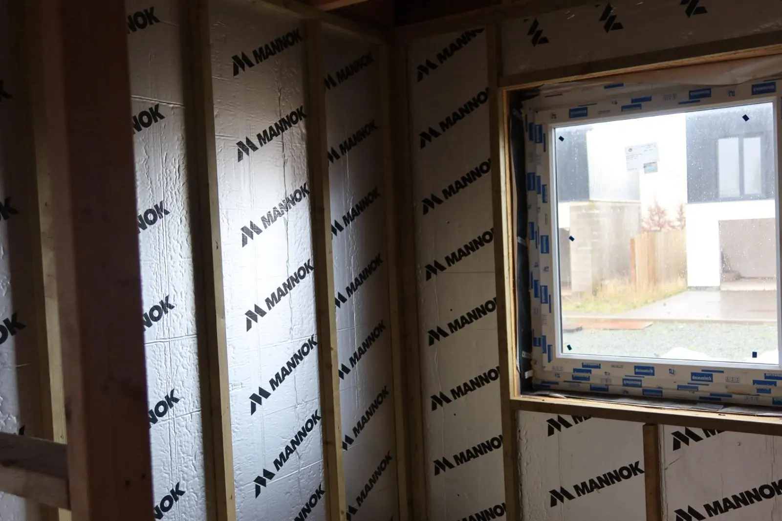 Internal wall insulation being installed with Mannok PIR boards between timber studs in a South Wales property.