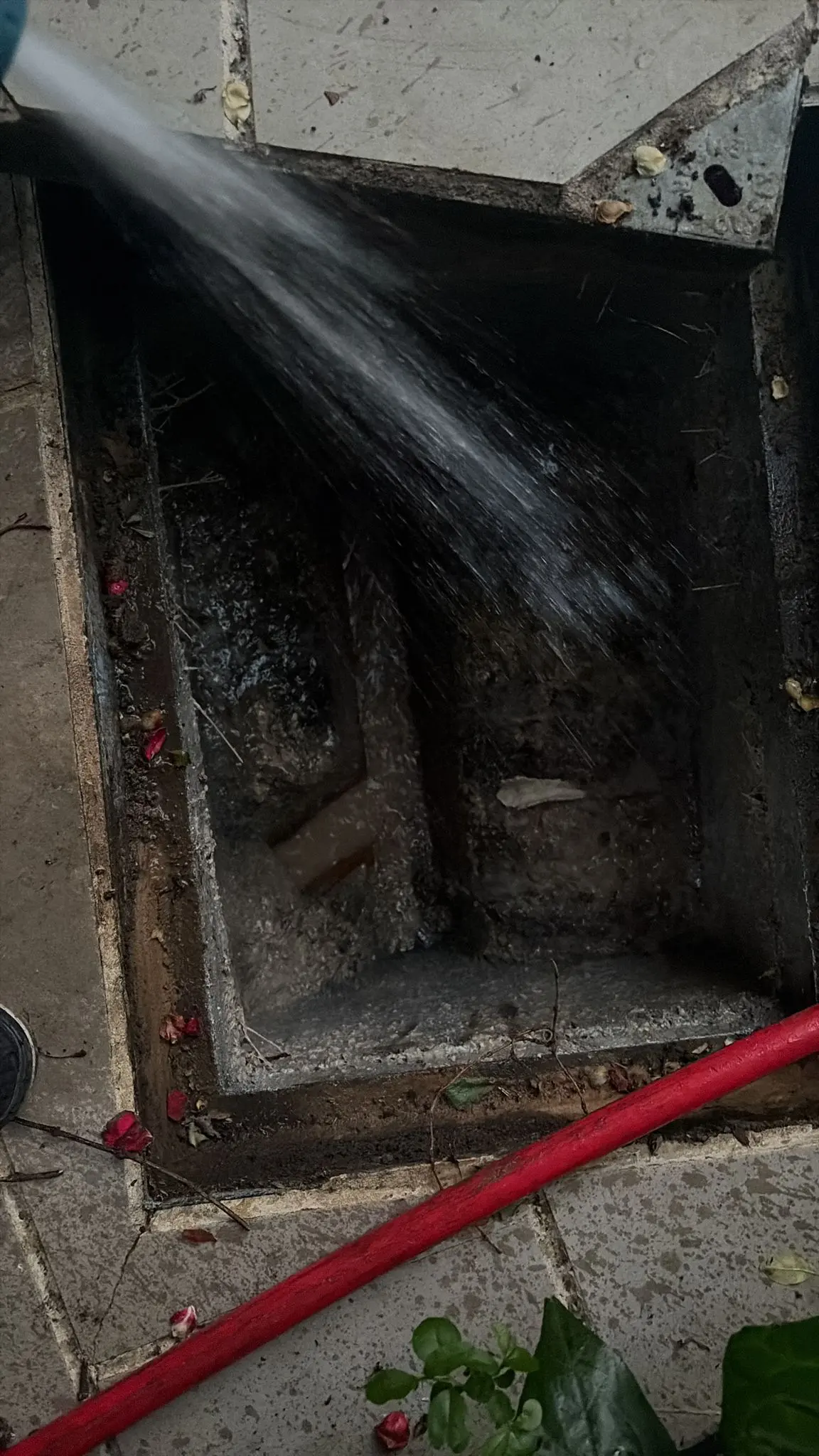 High-pressure drain jetting being used to clear a blocked drain chamber