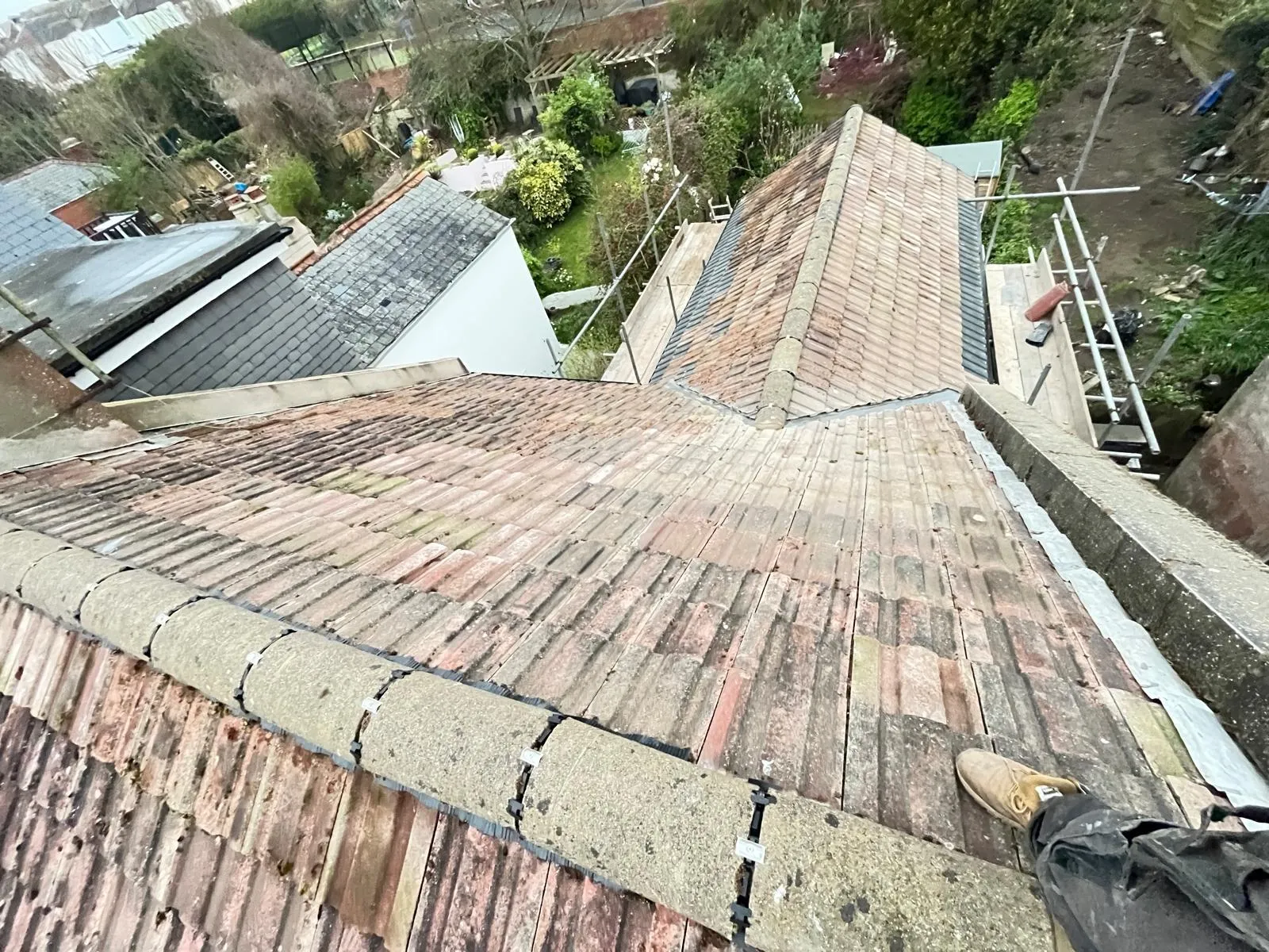 Professional pitched tiled roof installation with dry ridge system and scaffolding in West Malling, Kent