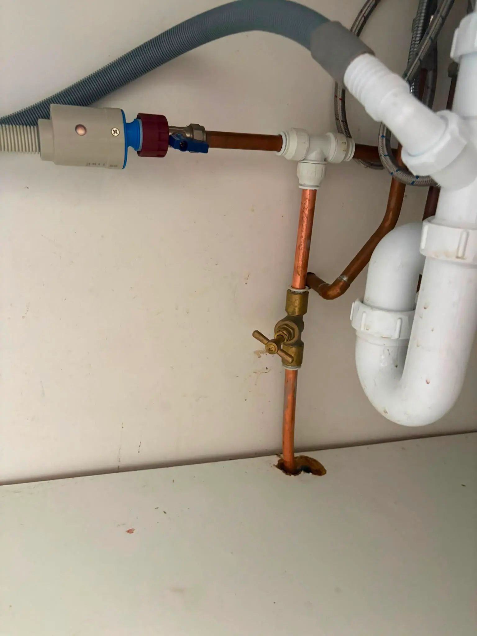 Under-sink plumbing pipework including a stopcock, valves, and waste trap