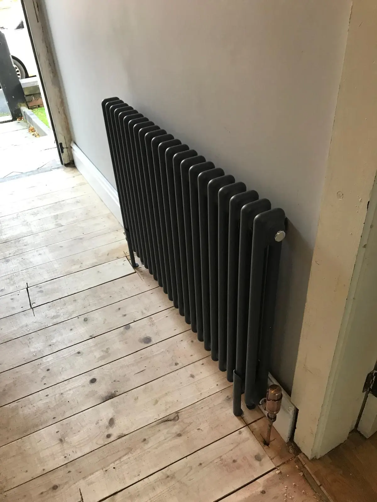 Modern anthracite column radiator installation in a Bolton home