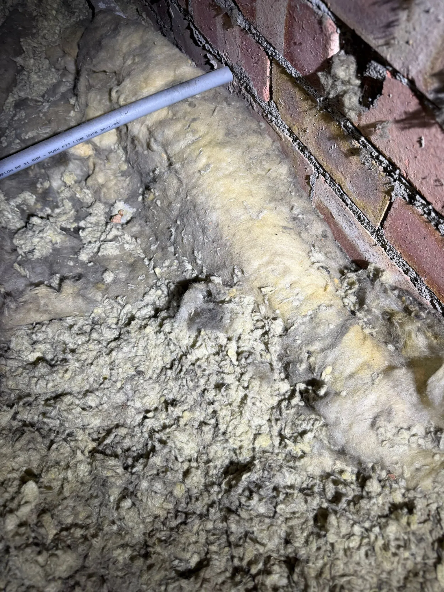Contaminated loft insulation in a Harrogate attic requiring professional pest cleaning services.