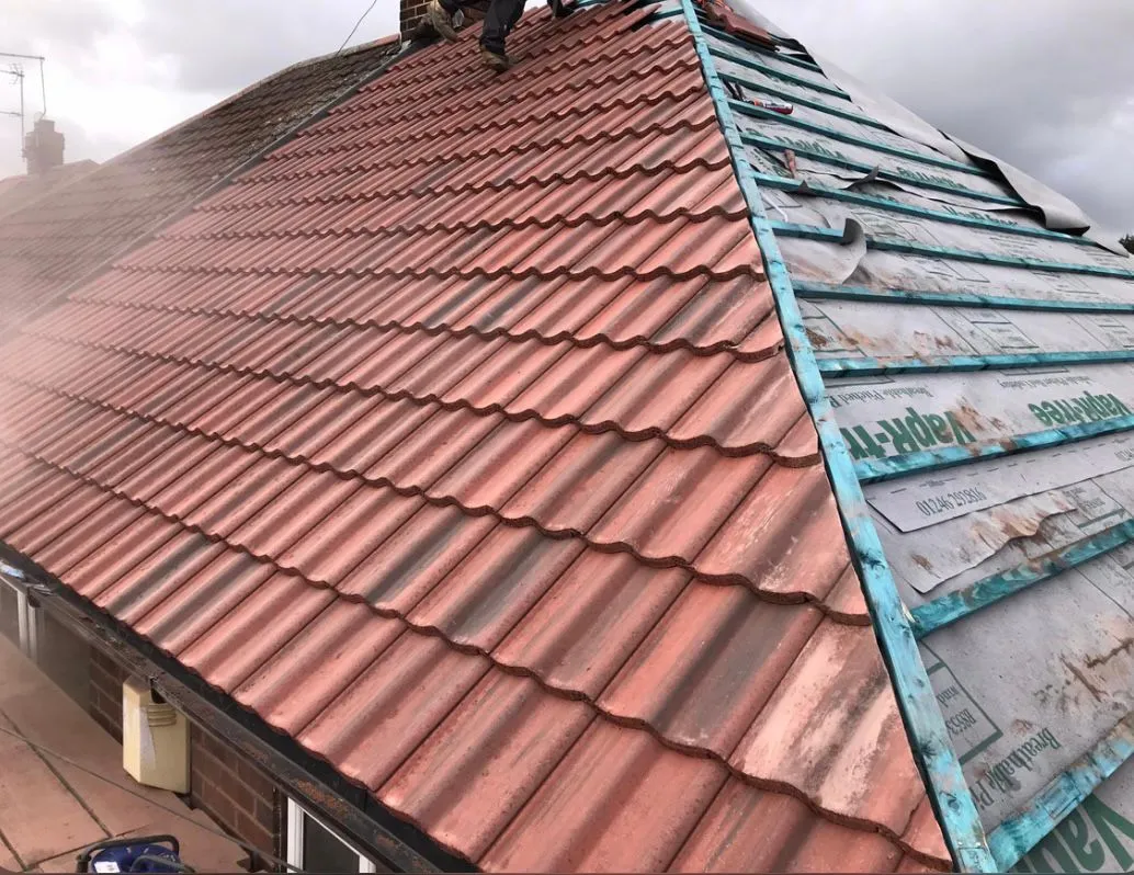 Professional new roof installation featuring red tiles and blue battens by Sky Top Roofing LTD in Devon and Cornwall.