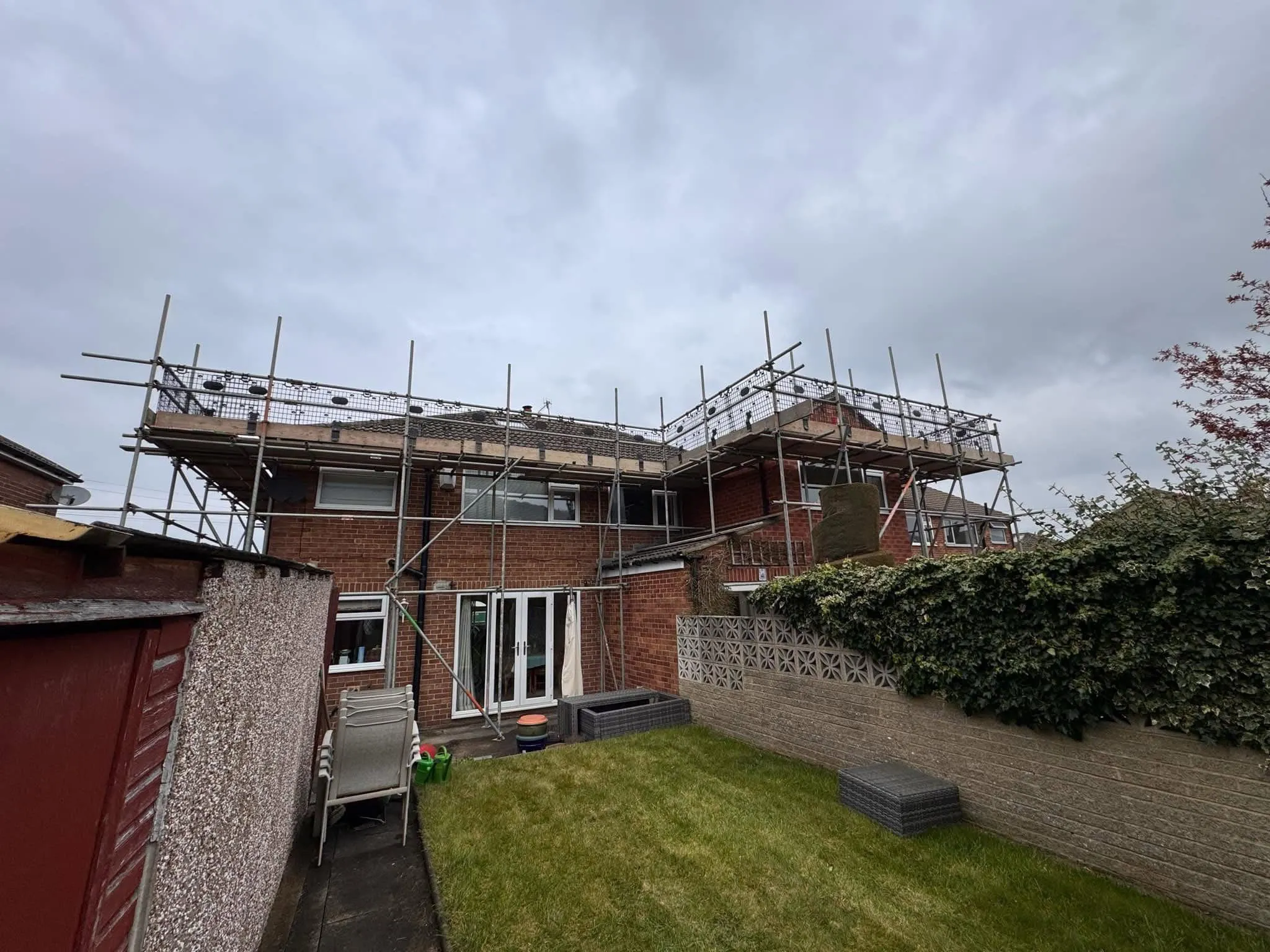 Scaffolding around a residential property for roofing services in West Yorkshire