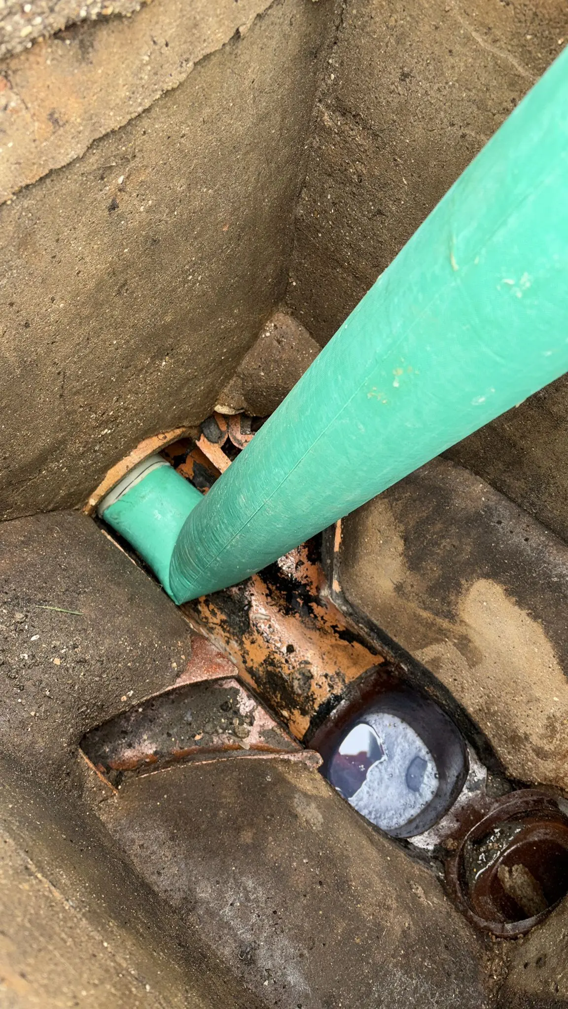 No-dig drain lining repair being installed in an underground drainage pipe to restore its structure.