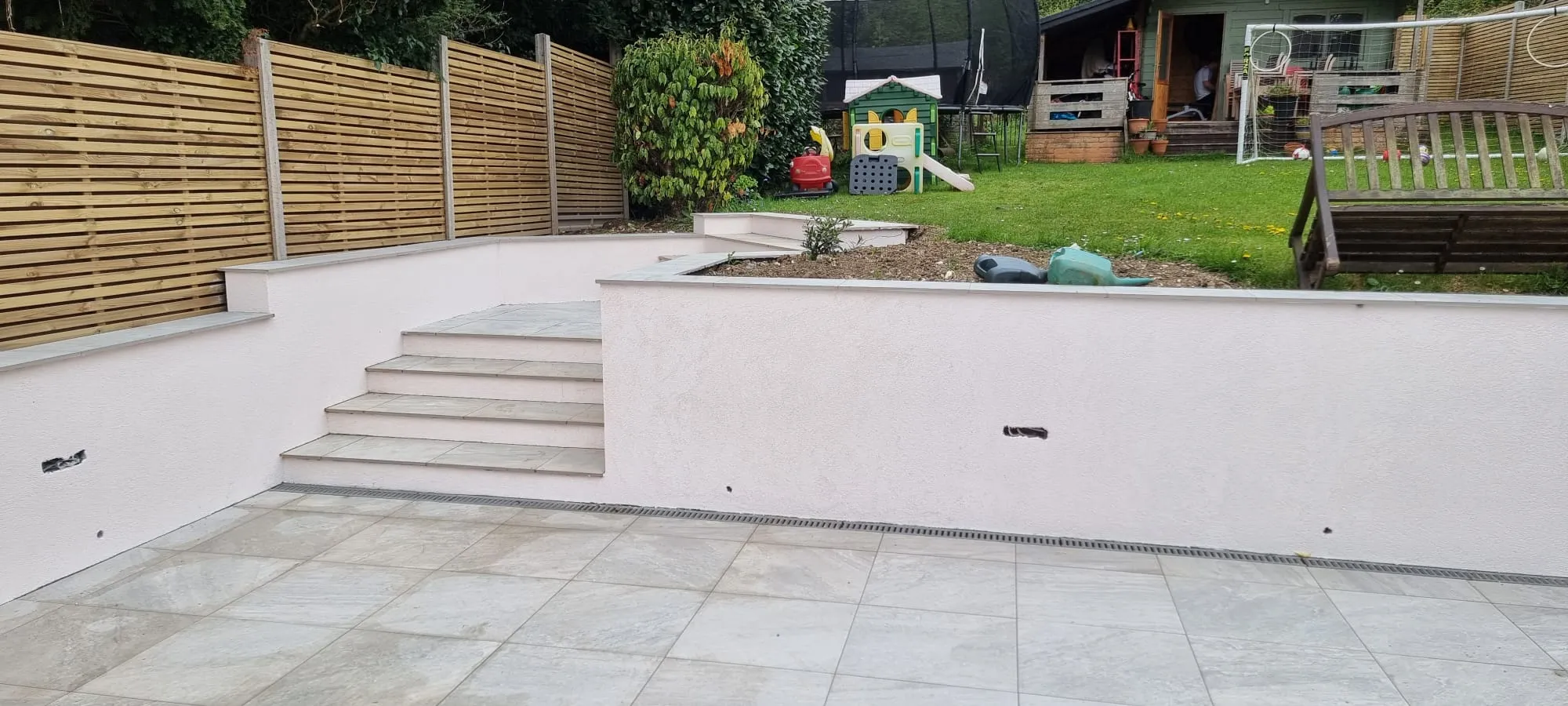 High-quality external rendering on garden retaining walls and steps by Portslade Plastering.