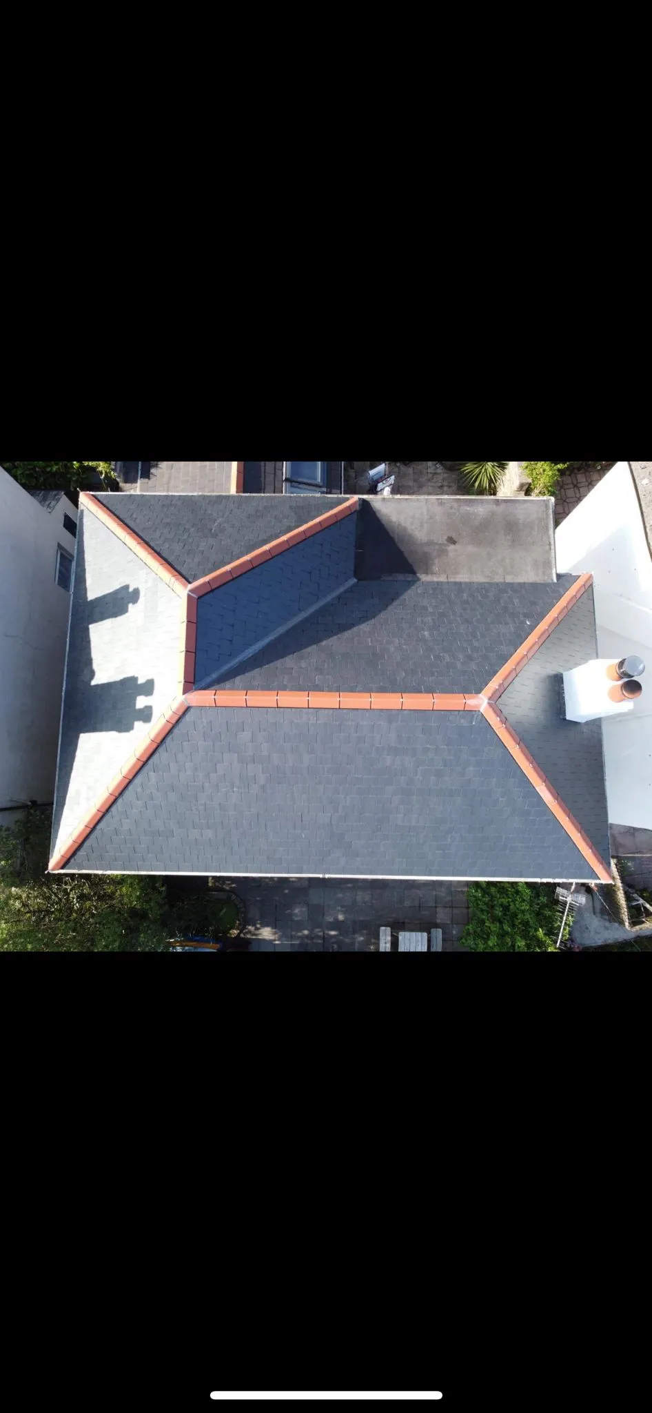 Aerial view of a professional slate and tile roof installation by Sky Top Roofing LTD.