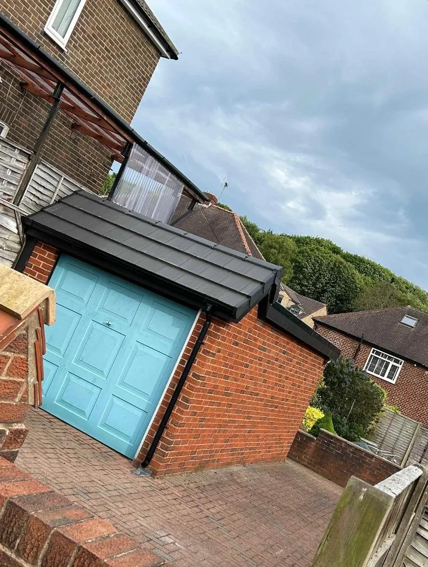 Newly installed tiled roof on a garage with a dry verge system.
