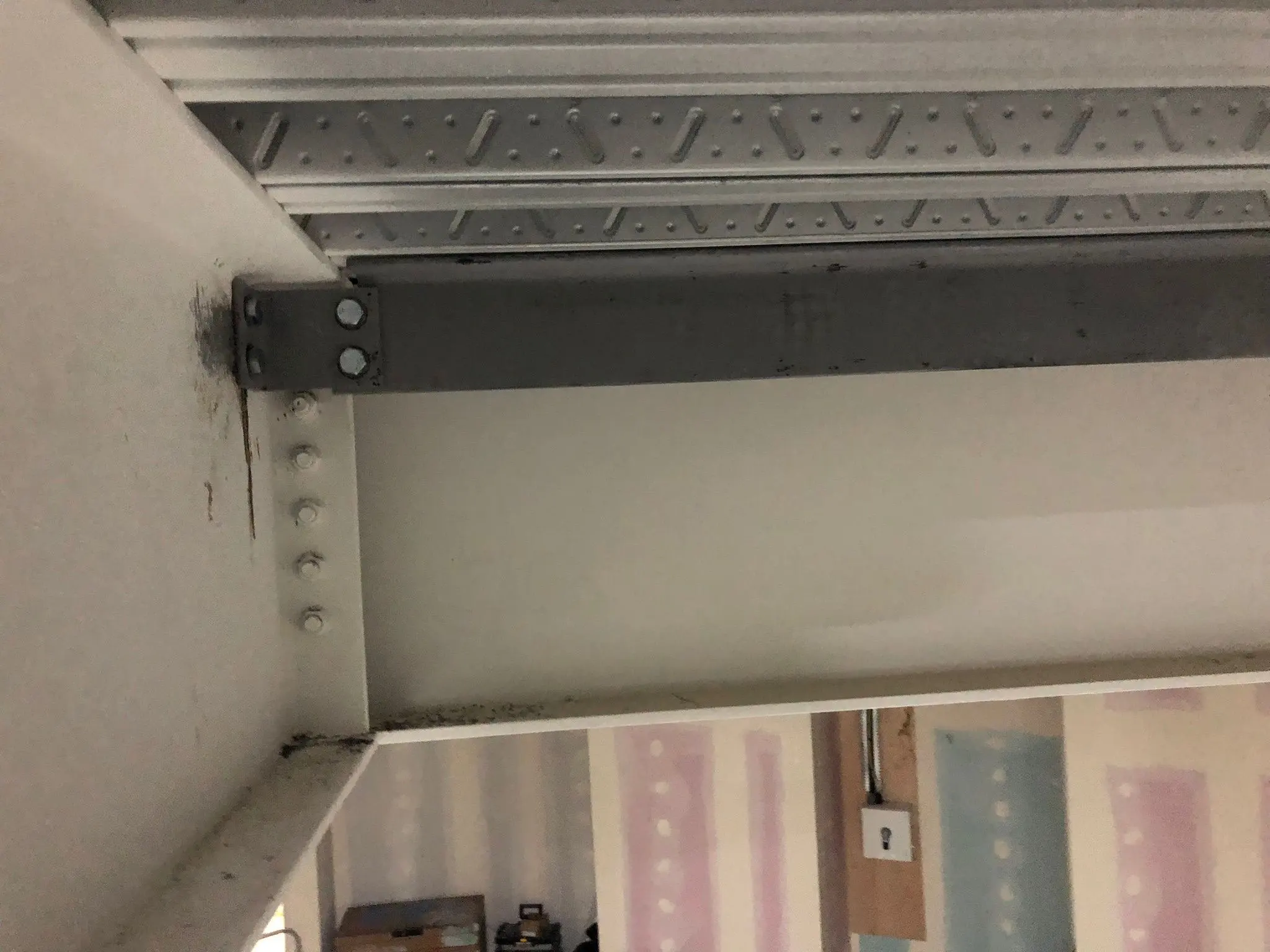 Bolted steel frame connection detail showing primary and secondary beams during erection.