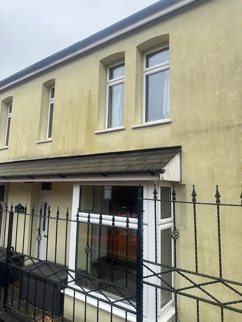Terraced house with aging render in South Wales, illustrating a property suitable for external wall insulation and new silicone rendering upgrades.