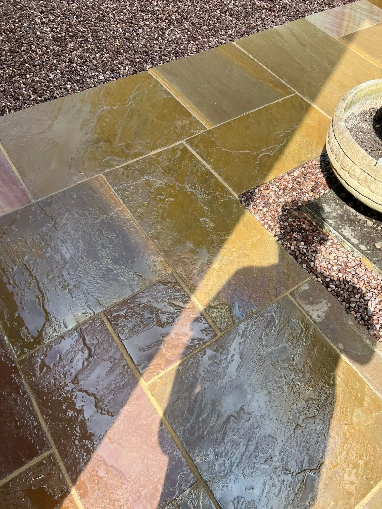 Professionally cleaned Indian sandstone patio showing natural stone colours and textures.