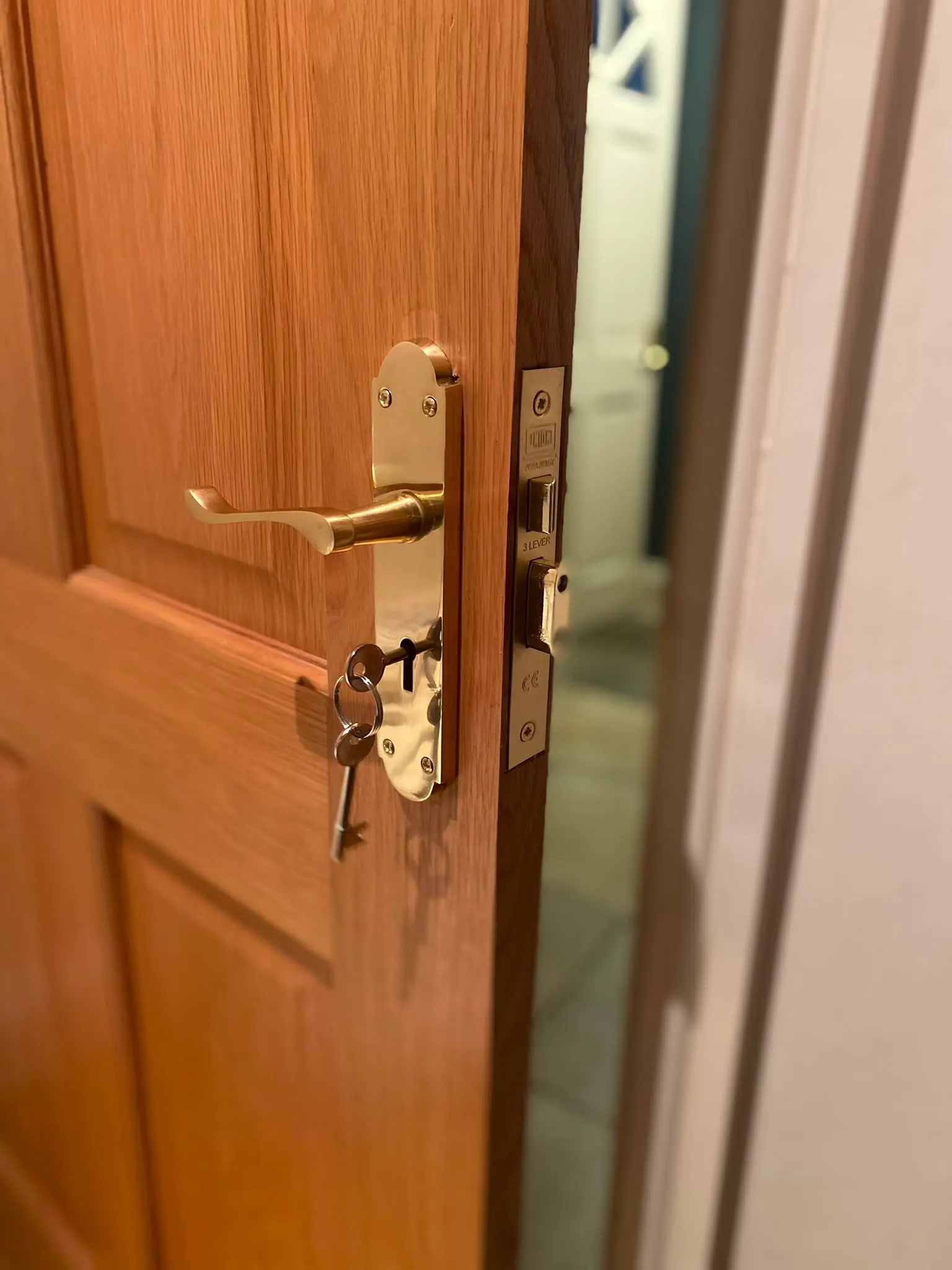 Professional mortice lock fitting: A newly installed brass 3-lever sashlock on a timber door by Locksafe York Ltd.