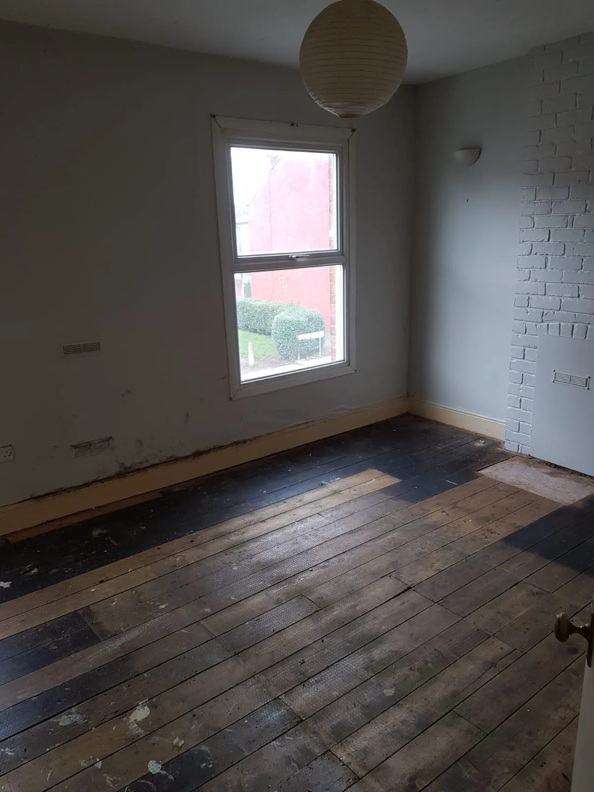 Empty bedroom with bare wooden floorboards following a licensed full house clearance in Birmingham