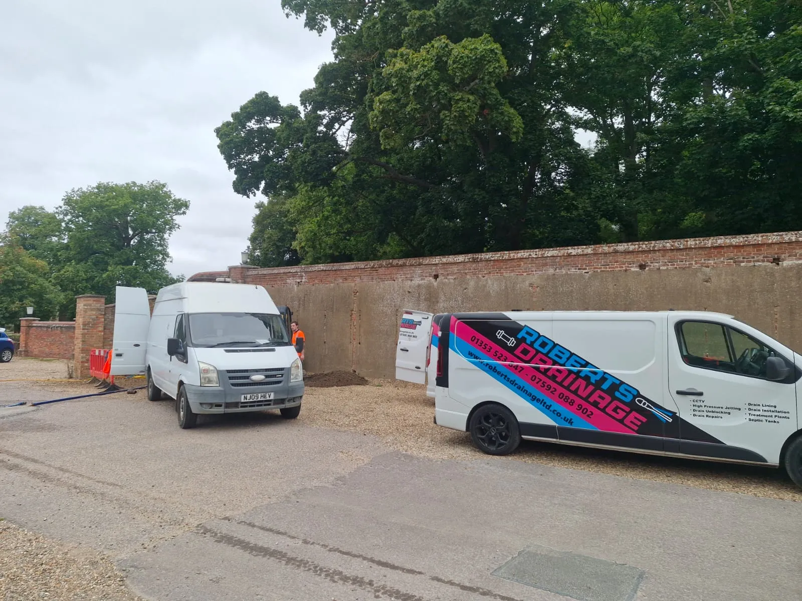 Roberts Drainage Ltd service vans on-site in Cambridgeshire.