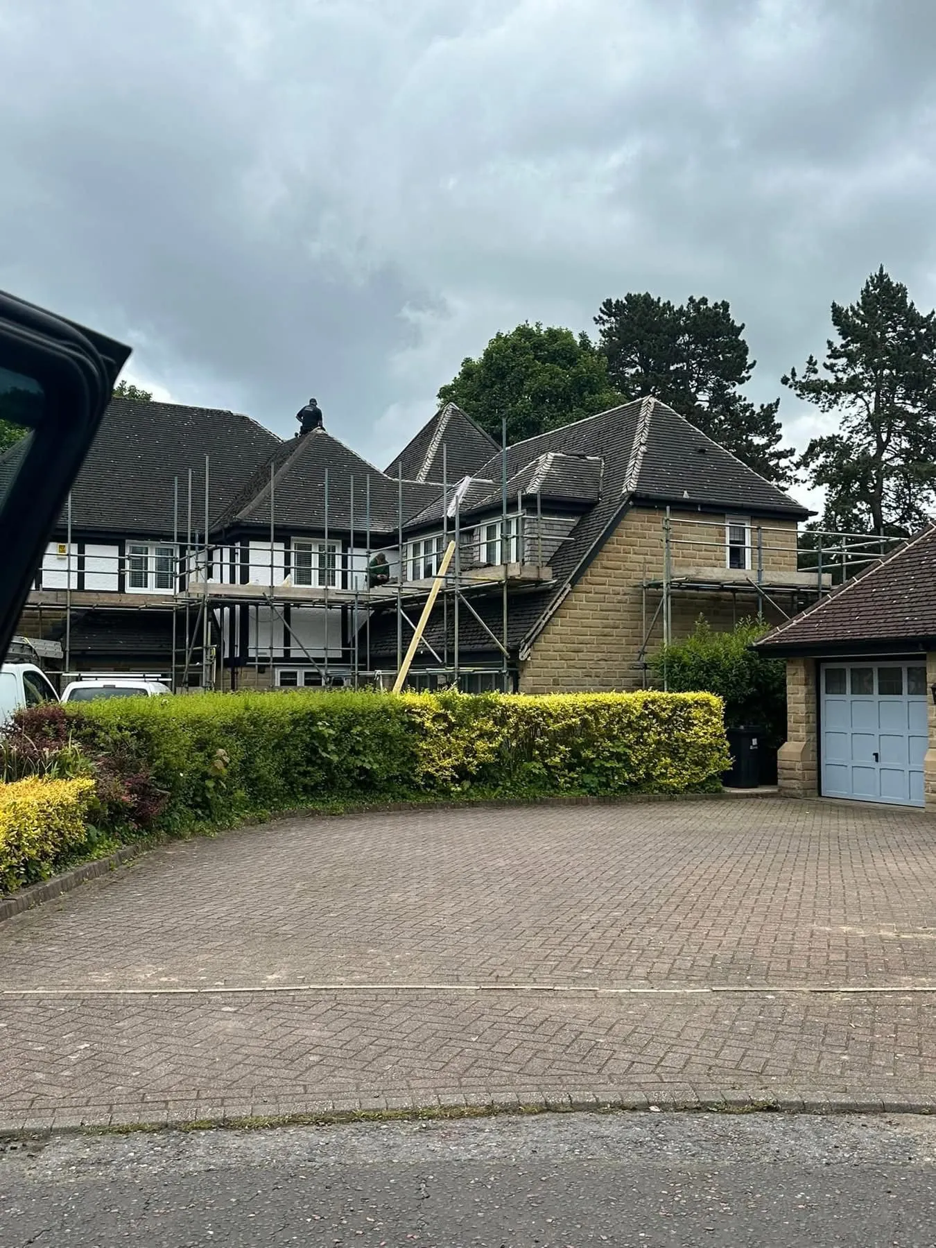 Professional roofing project with scaffolding on a large house in Otley, West Yorkshire