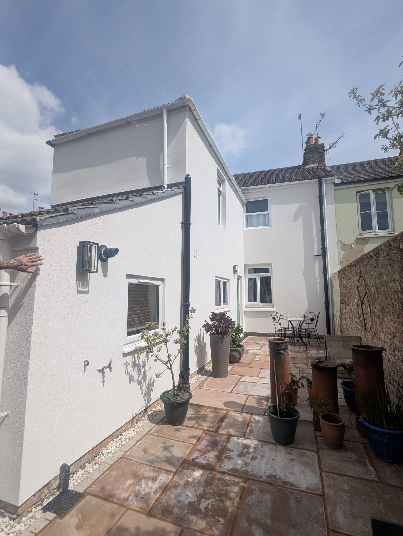 Freshly applied white external render on a residential property extension in Sussex.