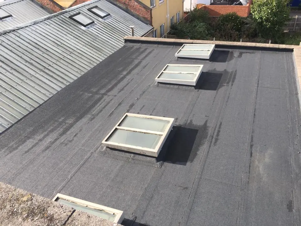 A completed torch-on felt flat roof installation with skylights by Amac Roofing