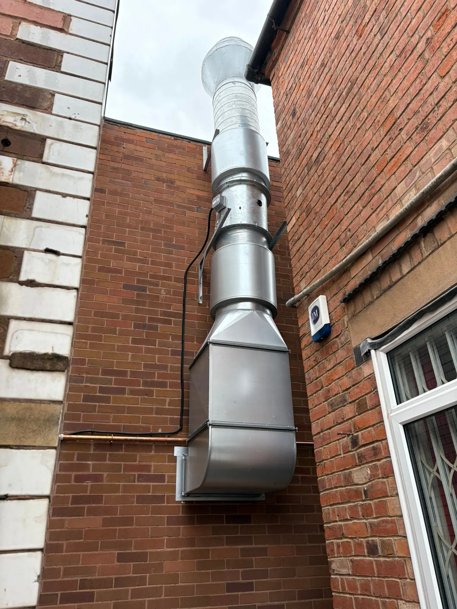 Commercial gas flue and extraction system installation on an external wall in Wolverhampton