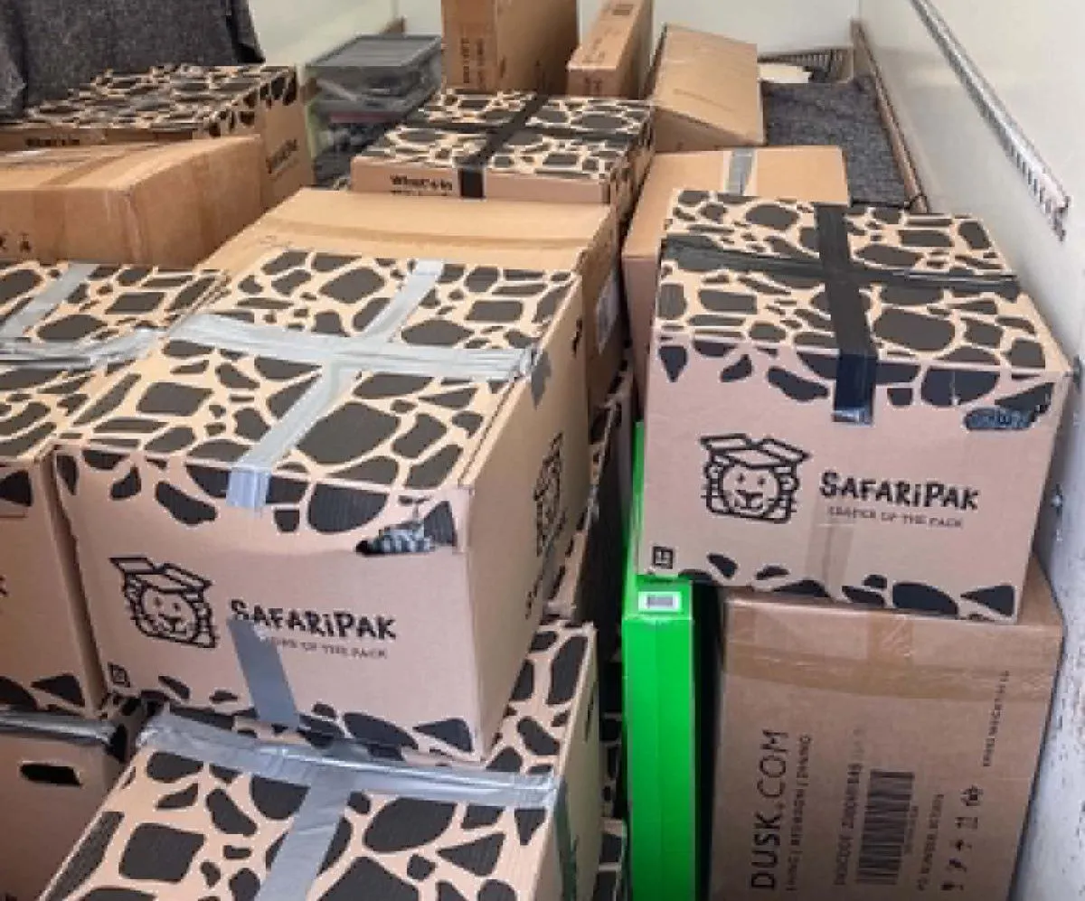 Heavy-duty cardboard packing boxes stacked securely inside an RM Removals van