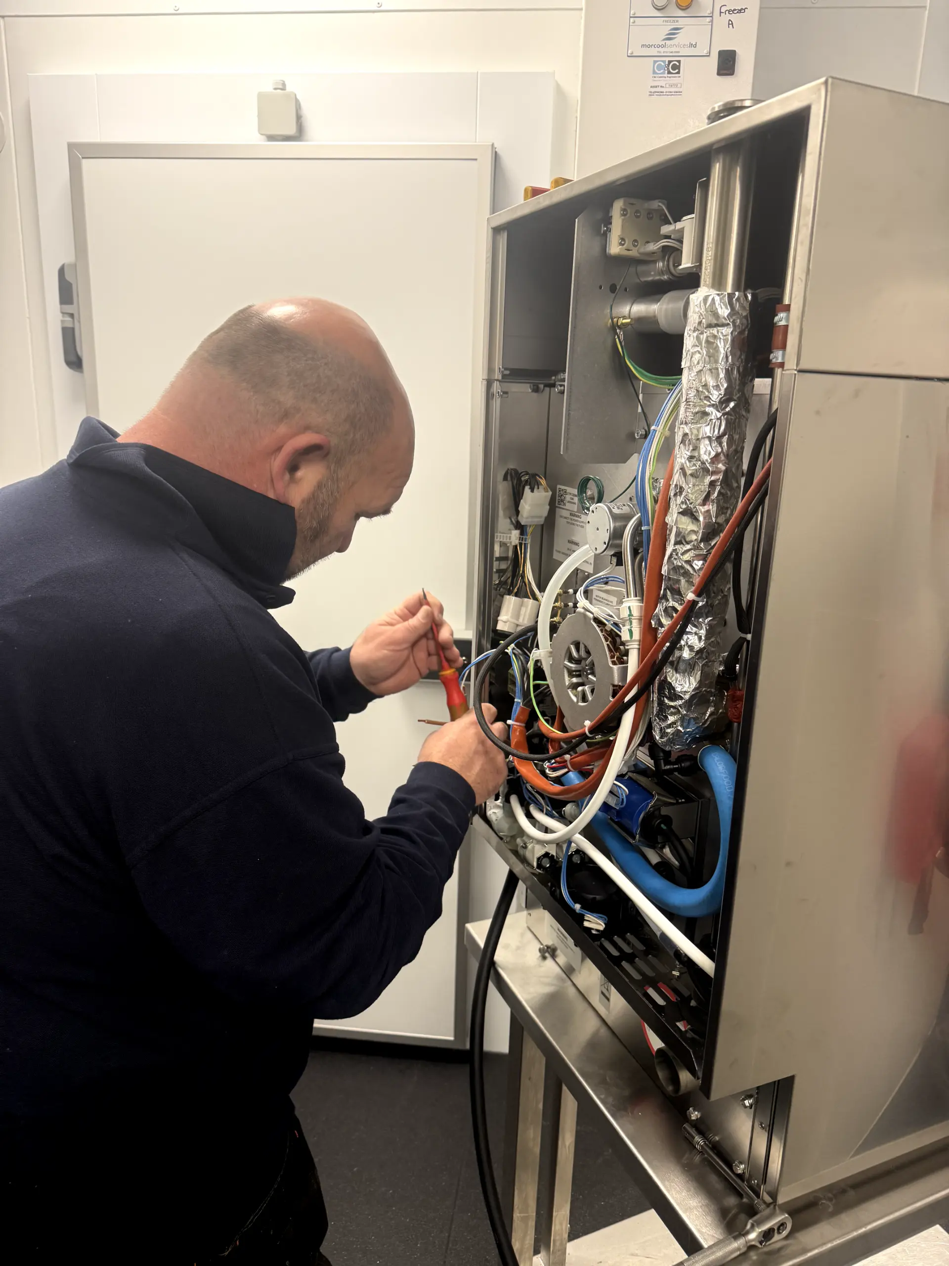 Gas Safe registered engineer from WGS Services repairing a commercial catering oven in Darwen.