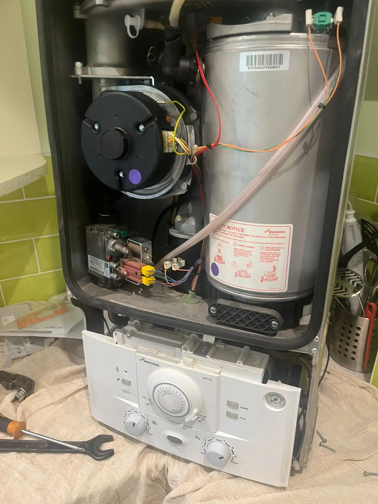 Internal components of a Worcester Bosch gas boiler being serviced by a Fact Services engineer in Wolverhampton.