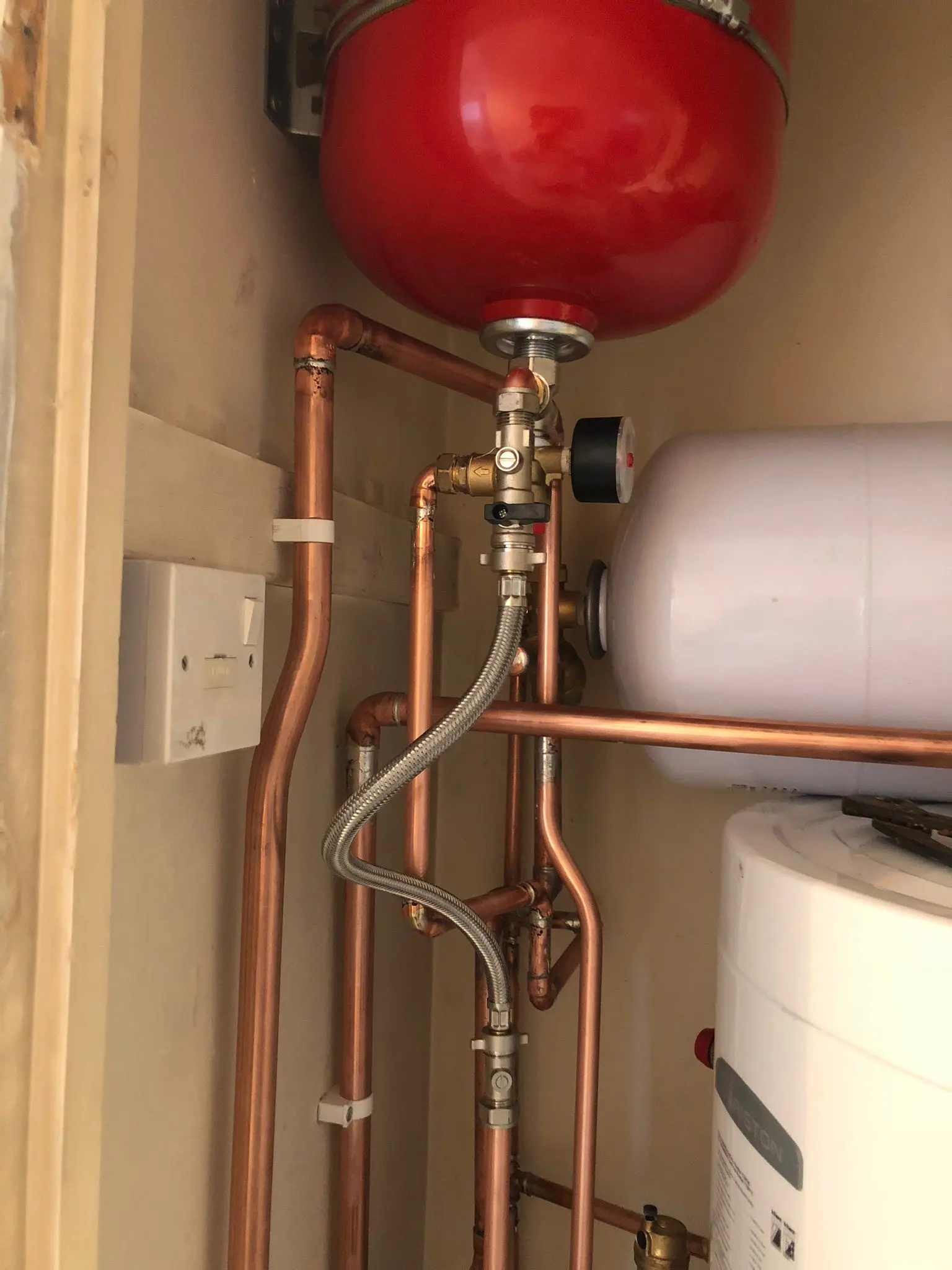 Professional central heating and water system installation by Fact Services in Wolverhampton showing expansion tanks and copper piping.