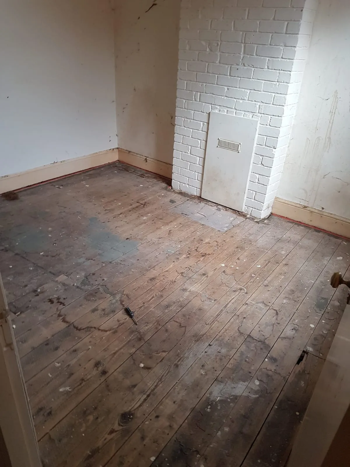 Cleared empty room with stripped wooden floorboards following a full house clearance in Birmingham