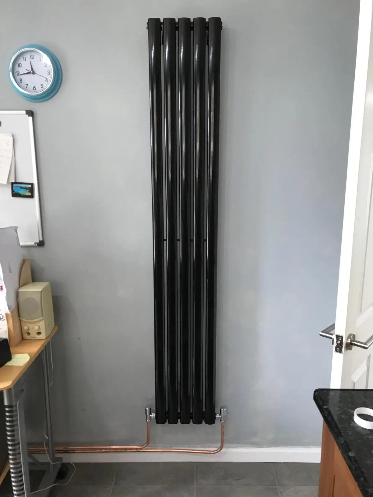 Modern vertical black radiator installation by MK Plumbing LTD