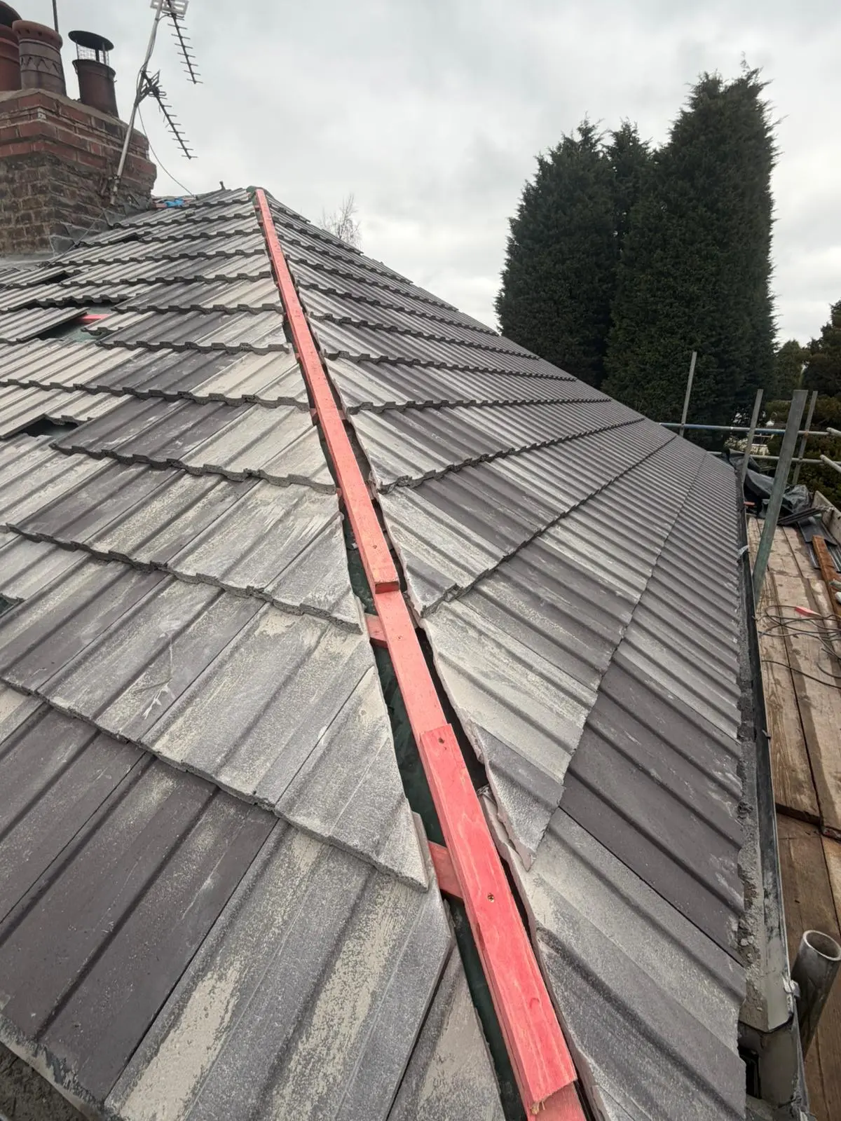 Preparation work for a dry ridge system installation on a tiled roof