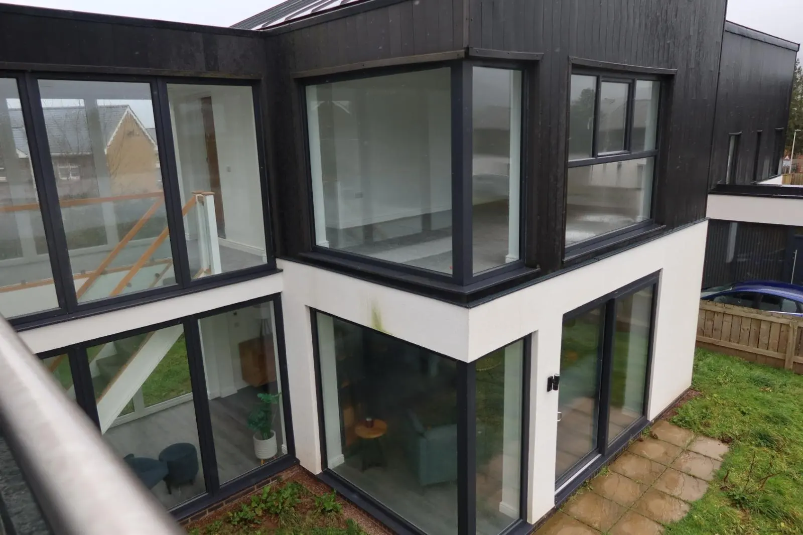 Modern detached property in South Wales featuring white silicone rendering and external wall insulation finishes.