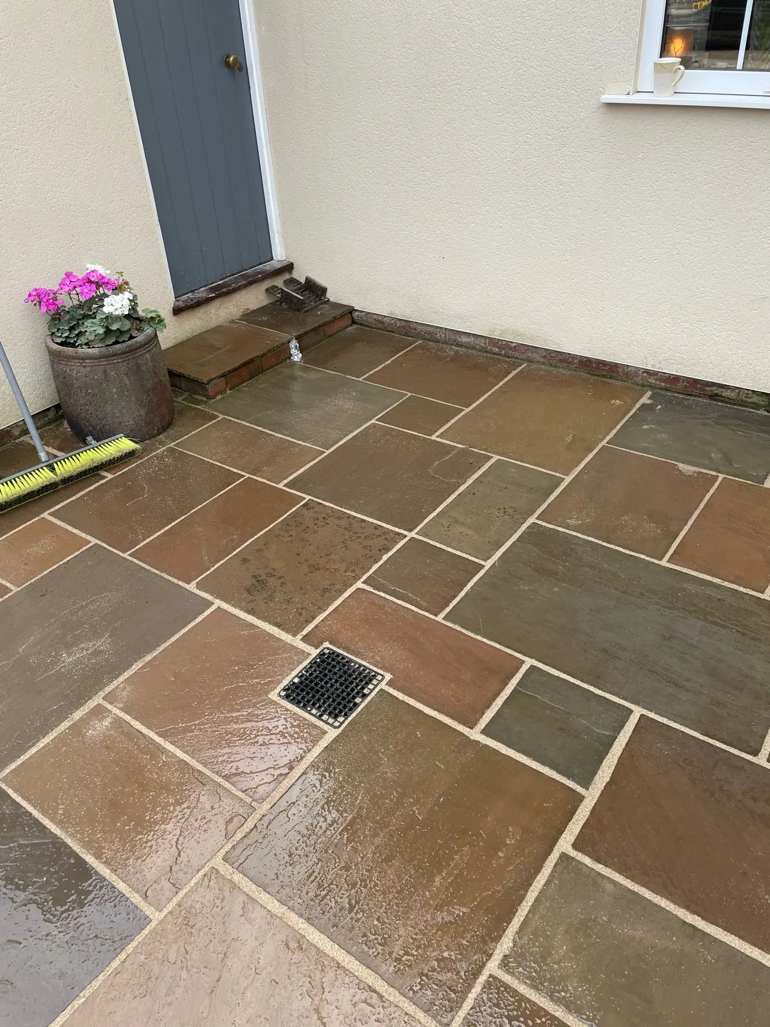 A newly installed sandstone patio with drainage