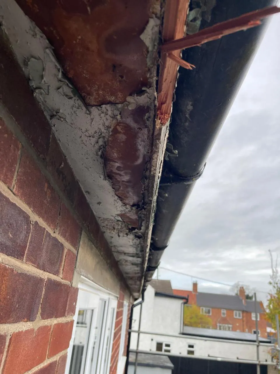 Deteriorated asbestos soffit, fascia, and guttering on a residential building