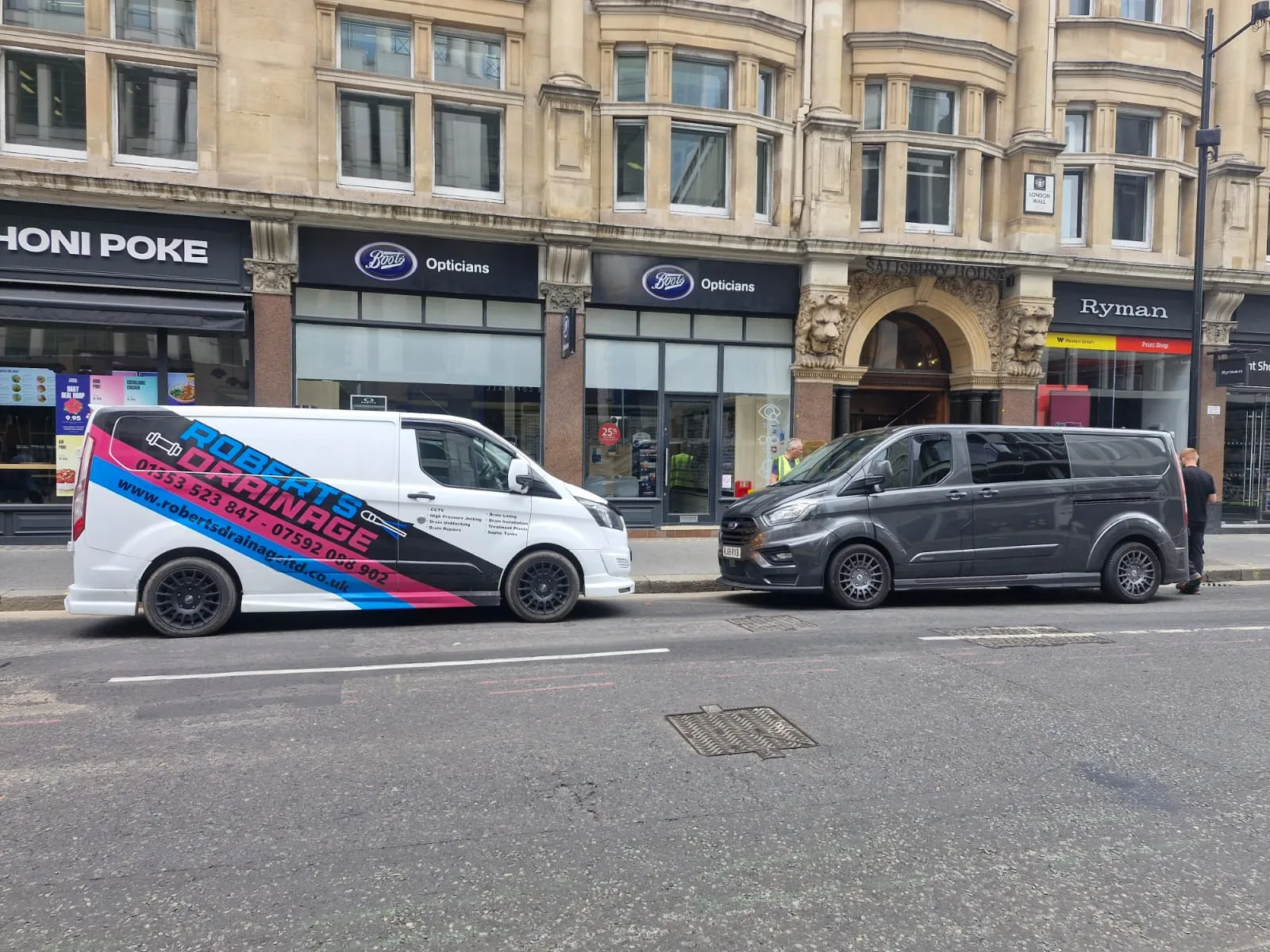A Roberts Drainage Ltd branded van parked on a city street for a commercial drainage job.