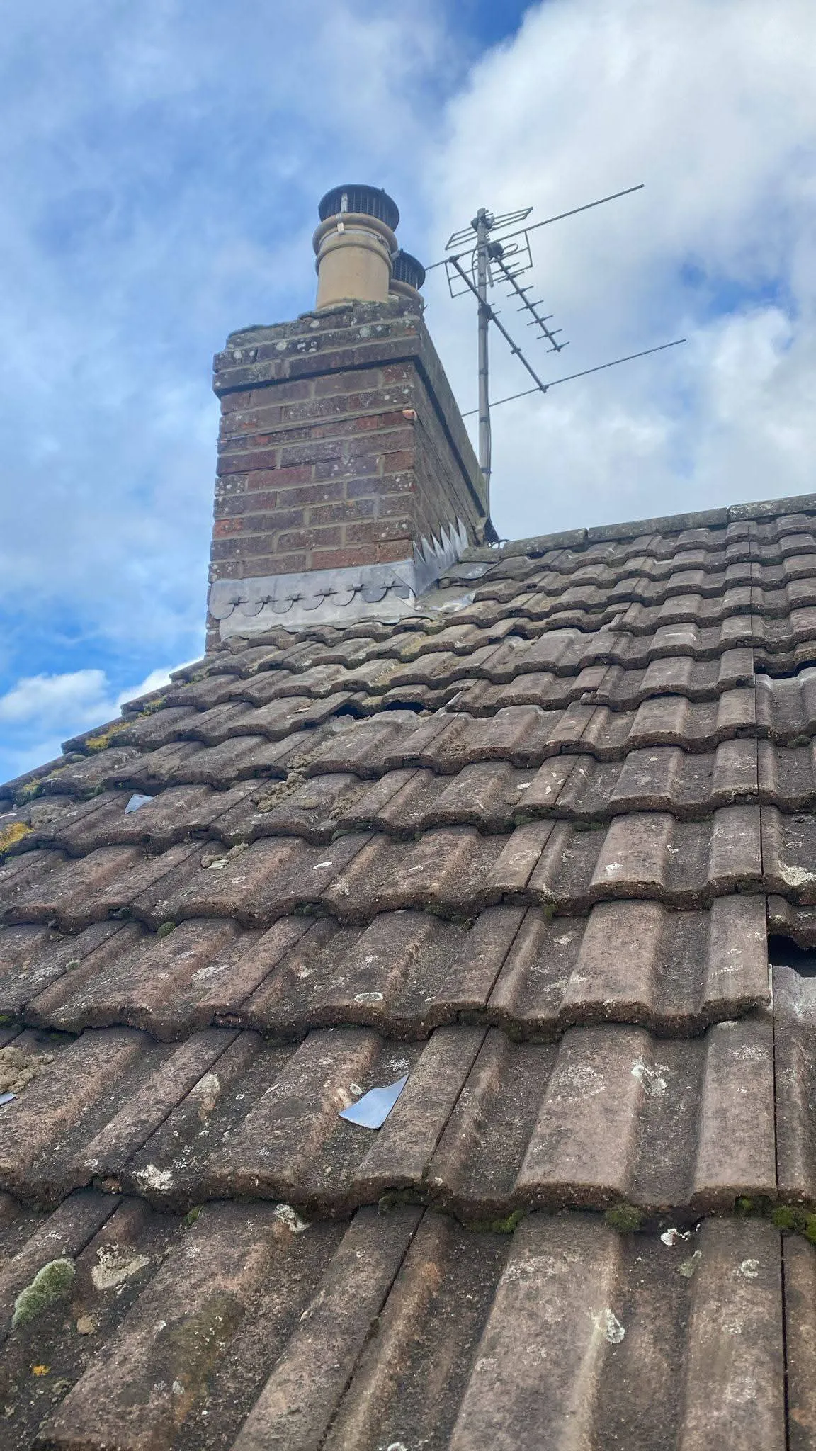Domestic tiled roof and brick chimney stack in need of maintenance and leadwork repairs by NTL Roofing.