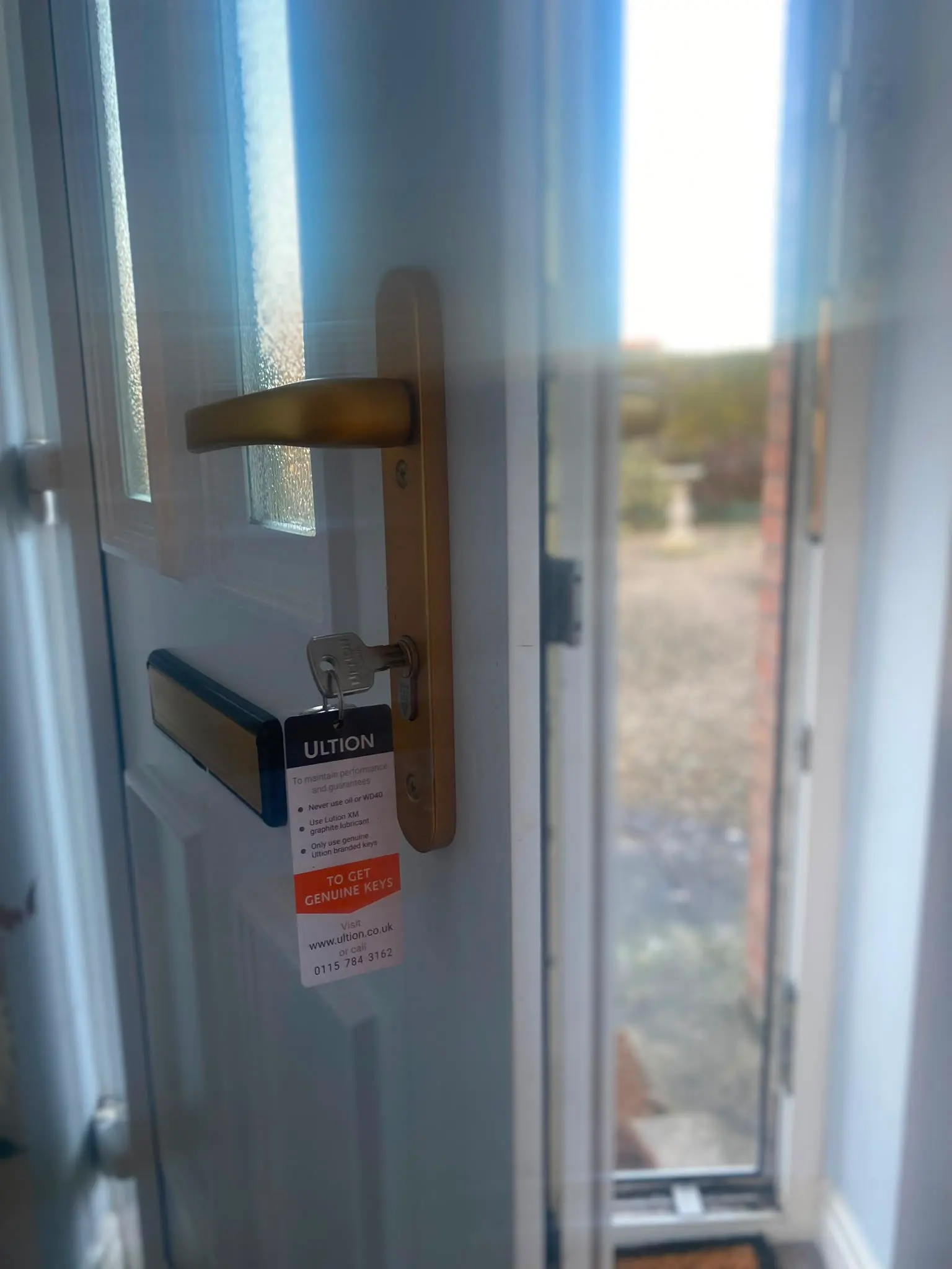High-security Ultion 3-star anti-snap lock and key installed in a white uPVC door by Locksafe York Ltd