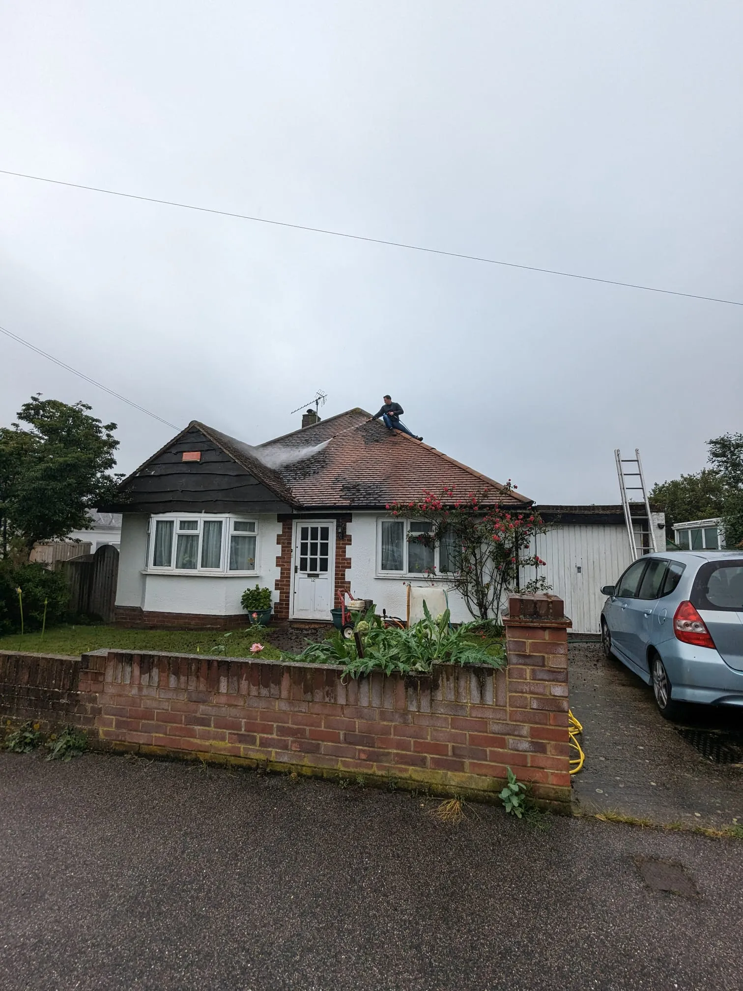 Professional roof moss removal and tile cleaning on a residential bungalow roof in Whitstable