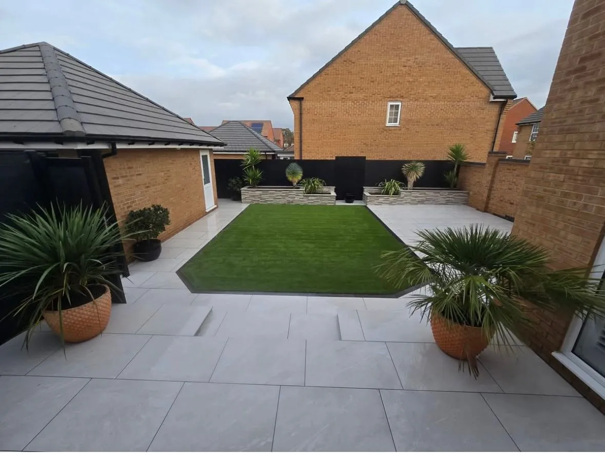 Modern garden renovation in Southend-on-Sea featuring premium porcelain paving and artificial grass installation by Foster and Sons Landscaping.